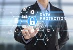 Businessman hand pressing button Data Protection