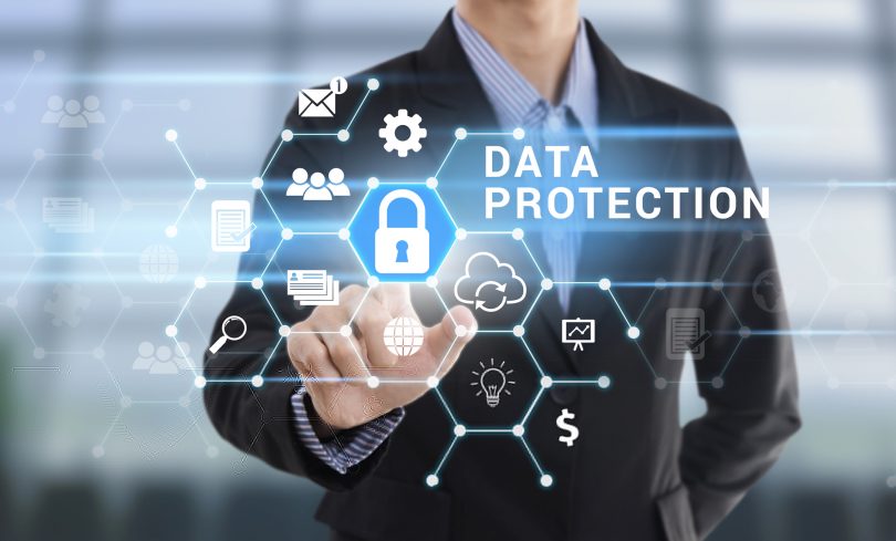Businessman hand pressing button Data Protection