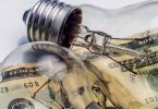 A lightbulb on dollar bill energy saving concept