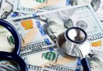 A medical stethoscope on dollars