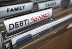 a file folder for debt becomes a folder for saving money after paying it all off