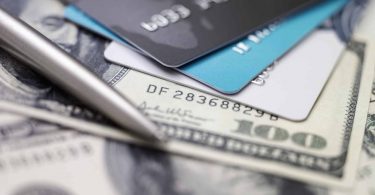 Credit card on dollars. Image concept of "is a balance transfer a good idea."