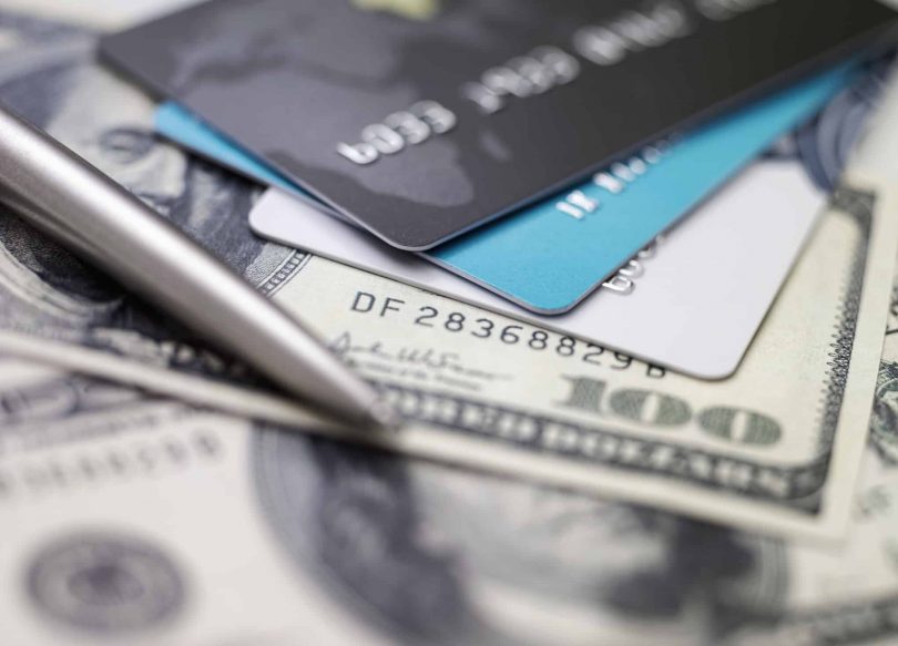 Credit card on dollars. Image concept of "is a balance transfer a good idea."