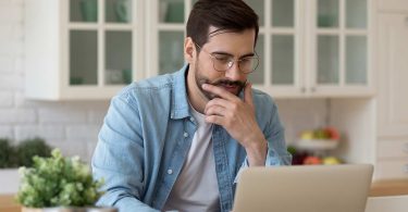 Young guy looking at notebook screen