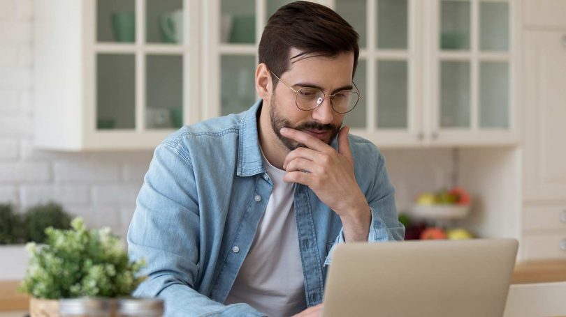 Young guy looking at notebook screen