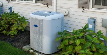 Heating and air conditioning inverter on the side of a house