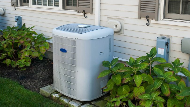 Heating and air conditioning inverter on the side of a house