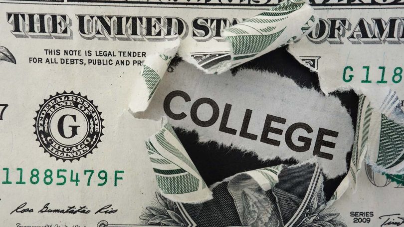 Paper headline with College text in torn dollar bill estudiar en la universidad