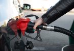 Woman refueling her car in a gas station
