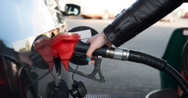 Woman refueling her car in a gas station