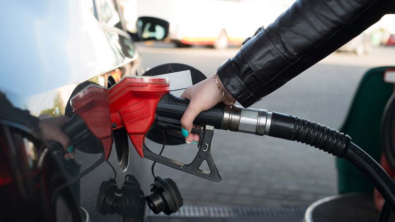 Woman refueling her car in a gas station