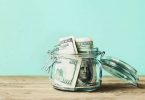 Dollar bills in glass jar. Saving money, economy, finance concept