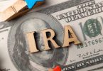 Top view wooden word and banknotes with text IRA