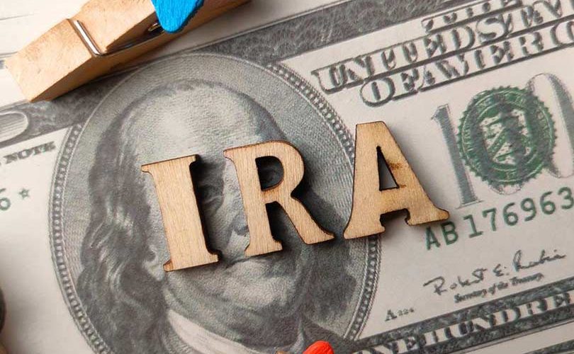 Top view wooden word and banknotes with text IRA