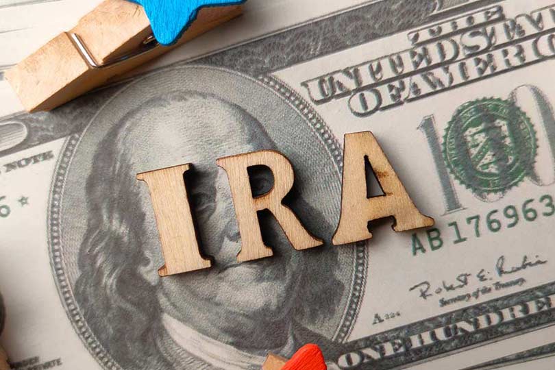 Top view wooden word and banknotes with text IRA