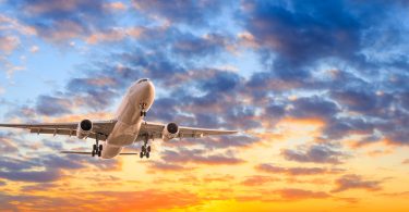 Commercial,Airplane,Flying,In,Beautiful,Sky,At,Sunset,travel,Concept.