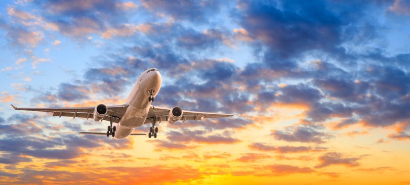 Commercial,Airplane,Flying,In,Beautiful,Sky,At,Sunset,travel,Concept.