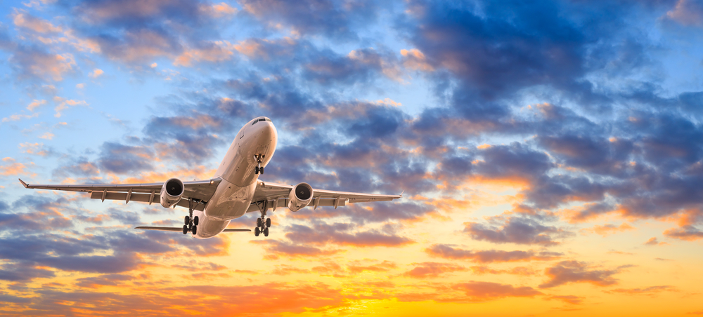 Commercial,Airplane,Flying,In,Beautiful,Sky,At,Sunset,travel,Concept.