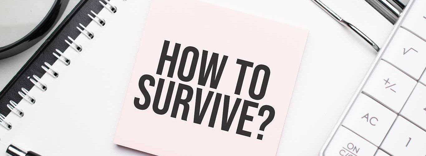 How to survive. Notepad, eyeglasses and white pen. Financial concept