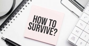 How to survive. Notepad, eyeglasses and white pen. Financial concept