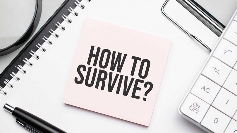 How to survive. Notepad, eyeglasses and white pen. Financial concept